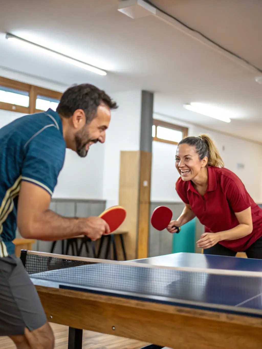 An image of adult players participating in a friendly table tennis match, showcasing the social and competitive aspects of the adult program.